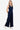 Side view of a denim jumpsuit, showcasing the flattering wide-leg cut and casual chic.