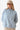 Woman wearing Baby Blue Half Zip Drawstring Mock Neck Hoodie, showcasing the trendy drawstring mock neck and half zipper.