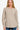 Woman wearing an H Beige curved hem sweater with long sleeves and a round neckline.