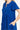 Woman wearing a royal blue notched short sleeve dress with pockets.