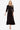 Elegant black midi dress with leopard trim, shown on a model in a frontal view.