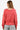 Back view of Women's coral ribbed knit top with long sleeves and exposed seam detail, showcasing a relaxed fit.