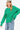 Side view of oversized emerald cable-knit sweater with a relaxed fit and eyelet sleeve detailing.