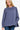 Women's indigo blue round neck sweatshirt with side slits and high-low hem, offering a relaxed fit and modern style.