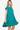 Side view of tiered dress on model showing the flattering silhouette and ruffle details.